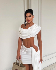 Mujer modelando el Set Pecado Blanco completo, con bolso de playa y sandalias altas