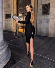 Vestido negro ajustado de KIKE RODRIGUEZ con escote en la espalda y cremallera, ideal para ocasiones especiales y eventos elegantes.
